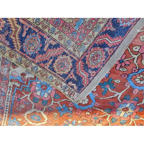 939A - A 19th century cream and red ground hand knotted Persian carpet with multiple borders and large cent... 