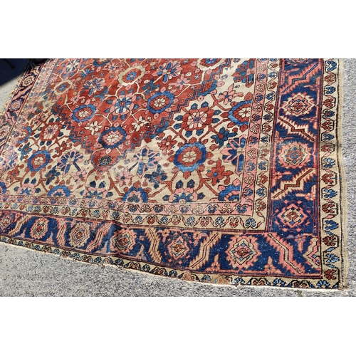 939A - A 19th century cream and red ground hand knotted Persian carpet with multiple borders and large cent... 