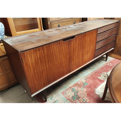 972 - A mid 20th century Richard Hornby for Heals designed teak long low sideboard with four drawers, doub... 