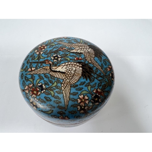 473 - A Chinese 19th century turquoise ground lidded circular pot with two cranes to the lid, fans and flo... 