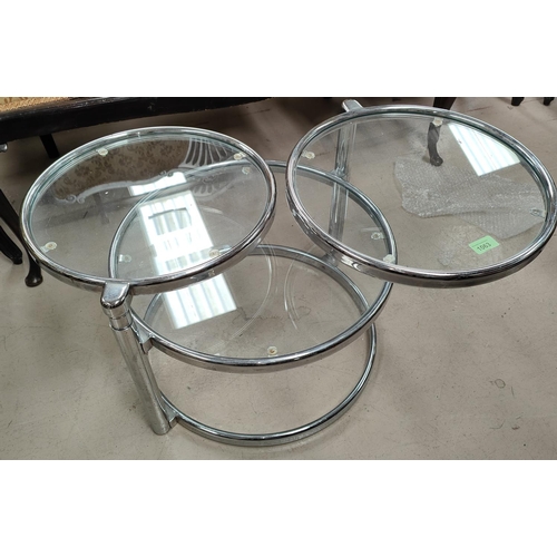 1063 - A 1970's style chrome and glass 3 tier circular nest of swivelling tables