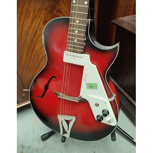 297 - A vintage Egmond Kansas semi-acoustic electric guitar on stand in red with shaped sound holes, singl... 