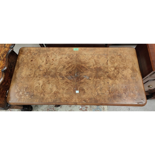 898 - A Victorian burr walnut card table with quarter veneered fold-over top and marquetry decoration, on ... 