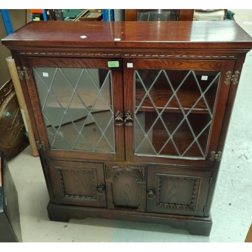 929 - An oak side cabinet with leaded glass double doors