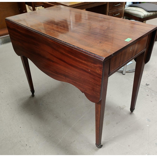 935 - A 19th century mahogany Pembroke table in the Sheraton style with serpentine leaves and frieze drawe... 