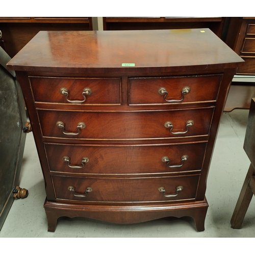 947 - A reproduction figured mahogany chest of 3 long and 2 short drawers on bracket feet by 