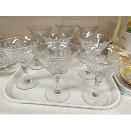 590 - A set of 9 saucer champagnes with floral etching; decorative glassware