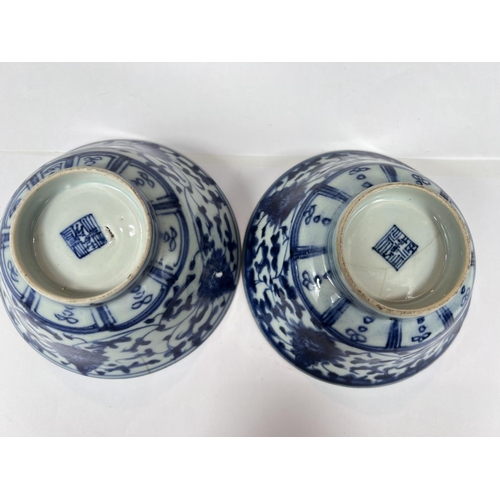 406 - A pair of Chinese 18th century blue and white bowls with scrolling floral underglaze designs, seal m... 