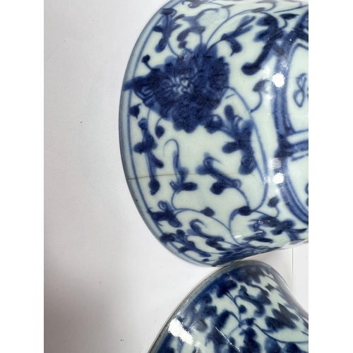 406 - A pair of Chinese 18th century blue and white bowls with scrolling floral underglaze designs, seal m... 