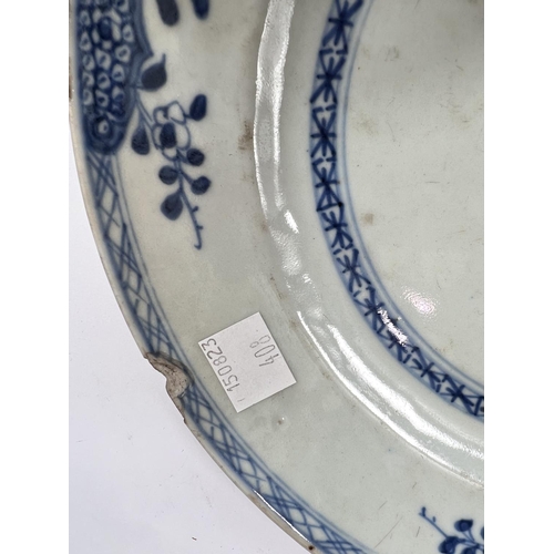 408 - A pair of Chinese 18th century blue and white plates with central floral display, dia. 23.5cm (chips... 