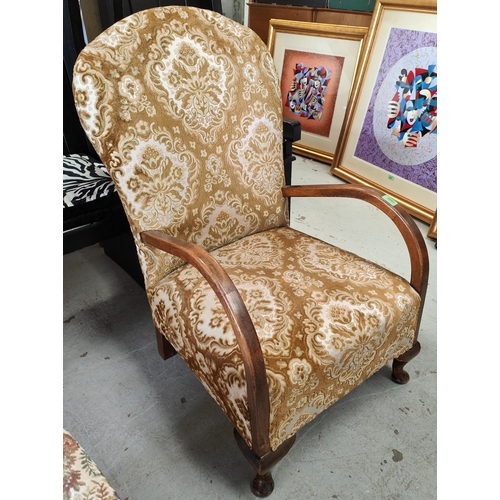 1008 - A 1930's oak framed armchair with gilt upholstery and a stick back rocking chair