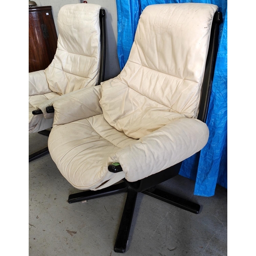 1062 - A pair of Gote Mobel armchairs in cream leather with ebonised frames, with labels to frame 