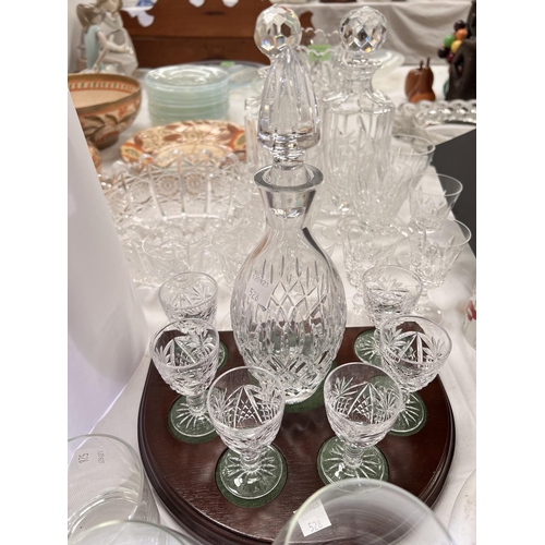 528 - A liqueur set; decanters; a cut glass vase; drinking glasses; etc.