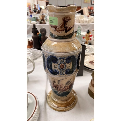 538 - A tall tapering stoneware jug by Martin Bros, the neck decorated with flying birds, the lower body w... 