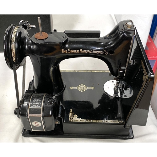 114 - A vintage small black cased Singer sewing machine with accessories 