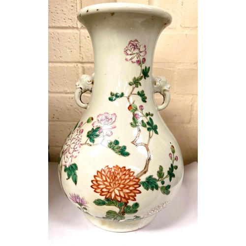 451 - A Chinese famille rose vase decorated with polychrome peacock and flowers, with elephant handles, ht... 