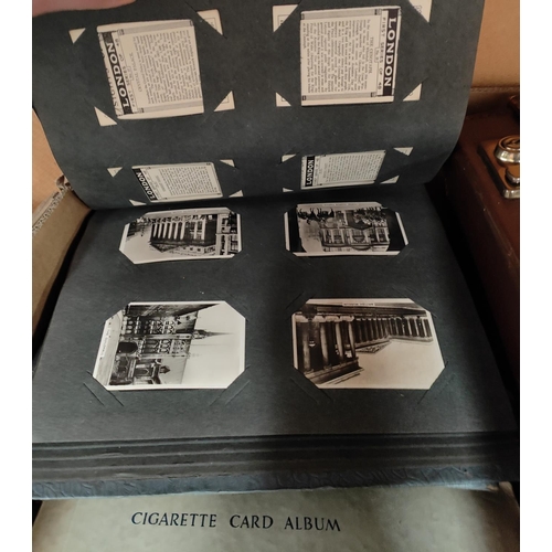 127A - A large collection of cigarette and trade cards in albums and loose; a small leather attaché ... 