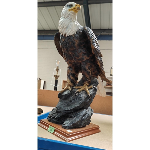 169 - A collection of items relating to Birds of Prey/Falconry including a large resin figure of an eagle;... 