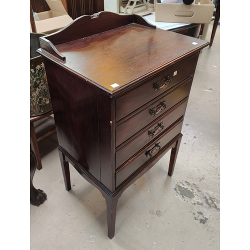 1035 - An Edwardian mahogany music cabinet with fall front music drawers; An oak three tier trolley, a gilt... 