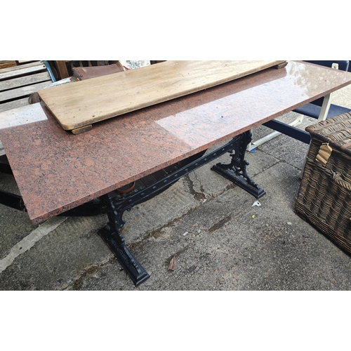 1042 - A cast iron garden table with polished granite top, the 19th century base by Gaskell's Bar Fitters, ... 