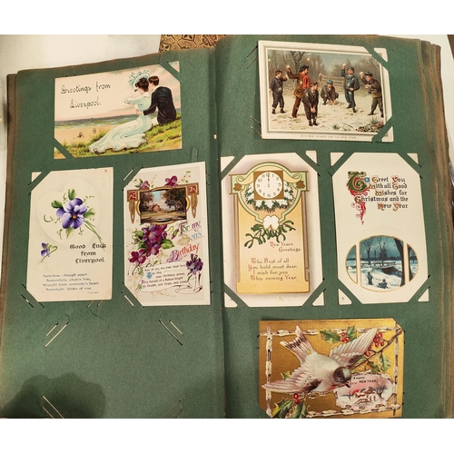 113 - A late 19th/early 20th century postcard album with various cards and ephemera