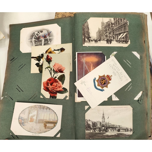 113 - A late 19th/early 20th century postcard album with various cards and ephemera