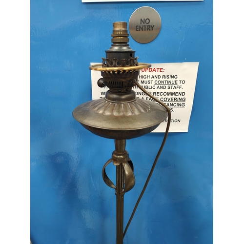 184 - An Arts and Crafts/ Art Nouveau brass standard lamp with fringed shade