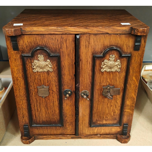 189B - An 19th century oak smokers cabinet in the form of a safe, with small safe handles etc