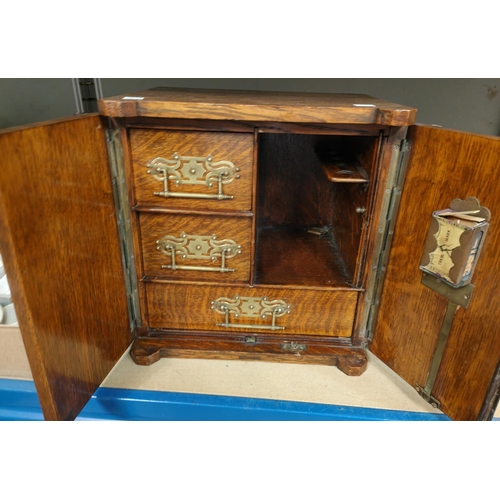 189B - An 19th century oak smokers cabinet in the form of a safe, with small safe handles etc