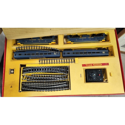 36 - A Tri-ang 00 gauge railway in original box; a boxed set of points; an Escalado game, boxed