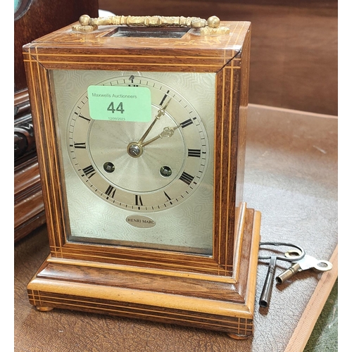 44 - A 19th century French mantle clock in inlaid rosewood case with silvered dial and striking movement ... 