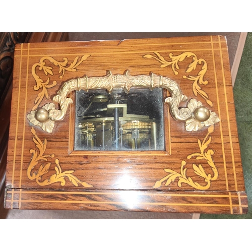 44 - A 19th century French mantle clock in inlaid rosewood case with silvered dial and striking movement ... 