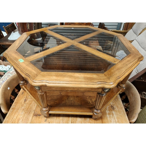 927 - An octagonal 2 tier coffee table with glass top