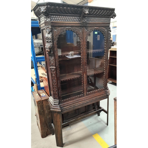 963A - A 19th century Gothic carved oak side cabinet on later supports 