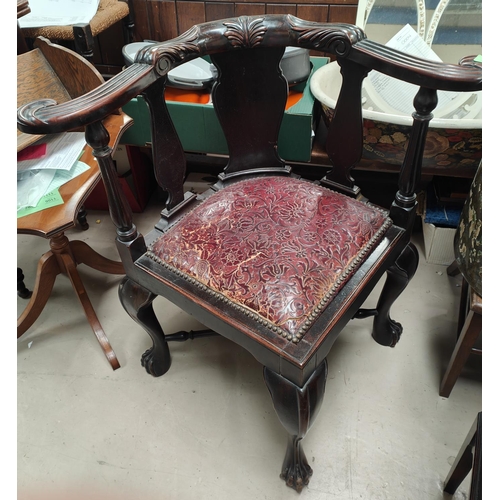 981 - A 19th century mahogany corner armchair with reeded arm rests, carved detail, cabriole ball and claw... 