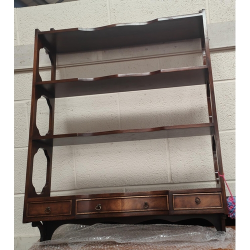 1028 - A reproduction mirror in the French manner; a reproduction wall hanging bookcase with drawers below