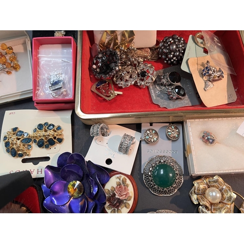 732A - A selection of decorative costume brooches, earrings and 2 jewellery boxes