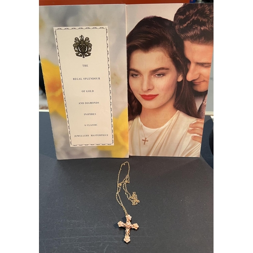 736 - A Stuart Devlin floral crucifix pendant in 14 carat rose gold, set diamond; a 14 carat gold chain