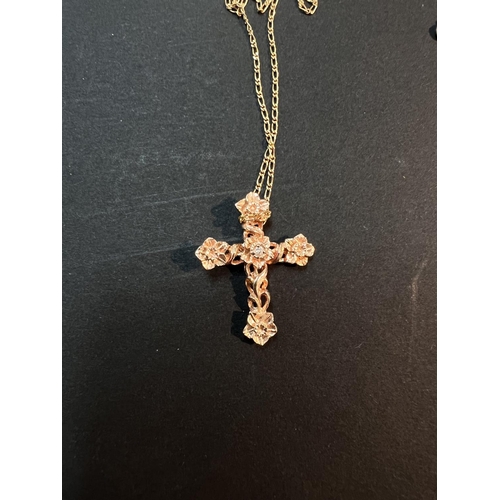 736 - A Stuart Devlin floral crucifix pendant in 14 carat rose gold, set diamond; a 14 carat gold chain