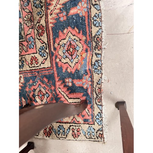 939A - A 19th century cream and red ground hand knotted Persian carpet with multiple borders and large cent... 