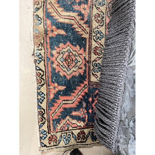 939A - A 19th century cream and red ground hand knotted Persian carpet with multiple borders and large cent... 