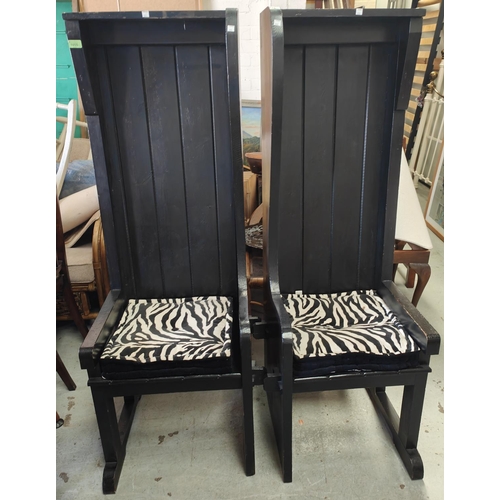 878 - A pair of unusual high back chairs in black finish