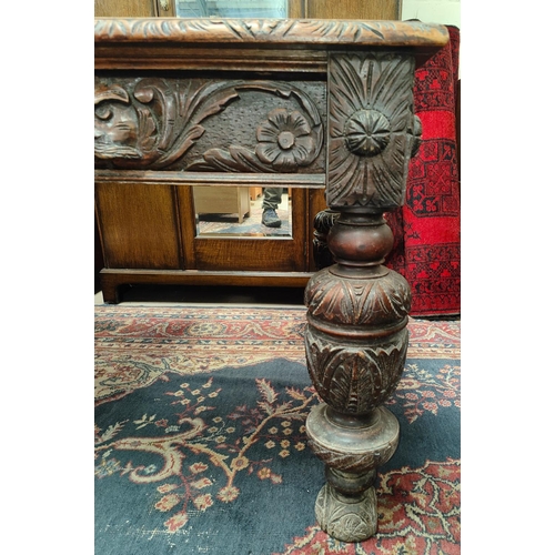 1001 - A large 19th century oak gothic style carved desk with two drawers with the green man carved decorat... 