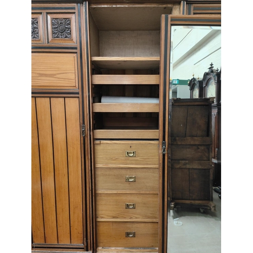 1015 - A 19th century ash triple wardrobe in the style of Lamb of Manchester with ebonised mouldings and in... 