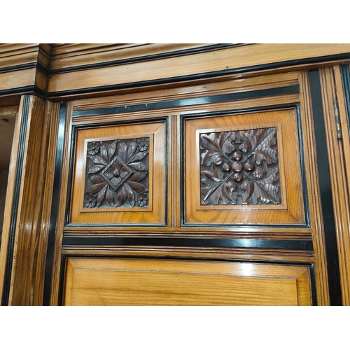 1015 - A 19th century ash triple wardrobe in the style of Lamb of Manchester with ebonised mouldings and in... 