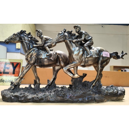 102 - A bronze effect group:  2 racehorses with jockeys