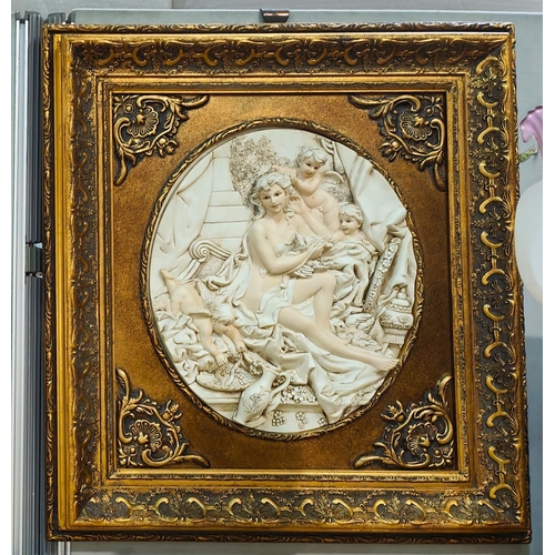 108 - A pair of wall plaques with relief panels of cherubs, in gilt frames