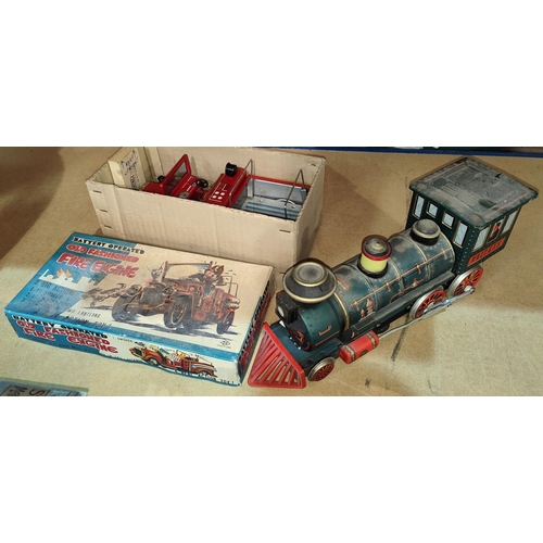 125 - A vintage boxed battery tinplate operated fire engine and a similar train