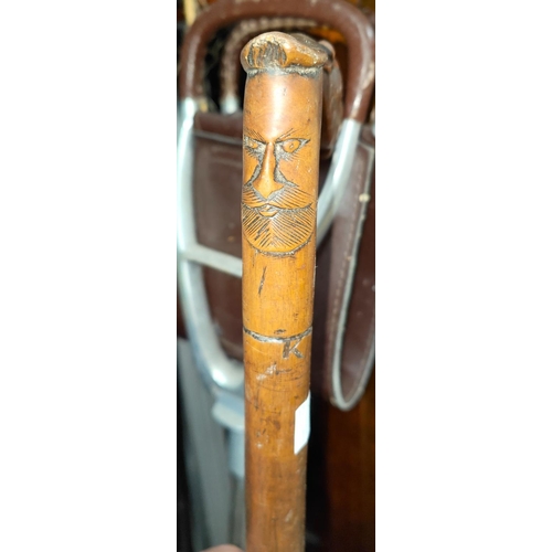 15 - A carved Chinese wooden walking stick, horse and face to top, a horn topped stick; shooting stick et... 
