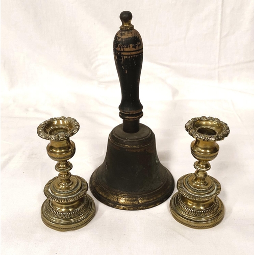 184 - A vintage brass hand bell and two 19th century brass candlesticks